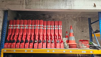 une étagère remplie d'extincteurs rouges et de cônes orange