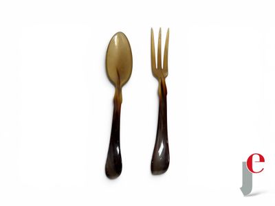 two forks and a spoon on a white surface