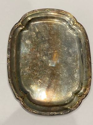 a silver tray on a white table with a white background