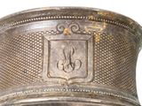 a silver cup that has a monogram on it