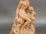 statue of a woman sitting on a rock with a child