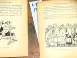 deux livres ouverts posés sur une table, sur lesquels figurent des dessins