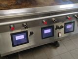 an image of a commercial gas grill in a kitchen
