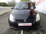 a small black car parked in a parking lot