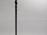 a black floor lamp with a black base and a white background