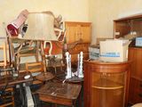 a lot of furniture in a room that is cluttered