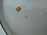 a white plate with a piece of yellow tape on it