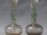 two vases that are sitting on a table