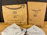 trois sacs de produits amazon posés sur une table en bois