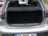 the back end of a silver car with its trunk open