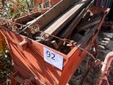 a pile of wood sitting on the ground next to a fence