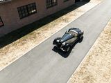 a car that is driving down the road in front of a building