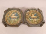 pair of decorative trays with birds on them sitting on a table