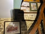 a picture on the wall above the stairs of a house