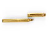 a pair of gold colored metal pens on a white background