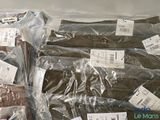 many bags of clothing that are wrapped in plastic