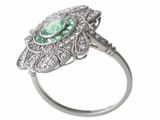 an image of a diamond and emerald ring on a white background