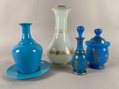 three vases and a saucer on a table