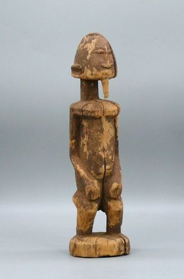 an old wooden statue of a man with a helmet on his head