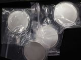 four cups of coffee in plastic bags on a table