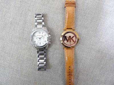 two watches sitting next to each other on a table