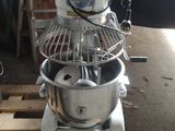 a mixer that is sitting on a pallet in a garage
