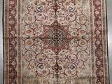 an antique persian rug with a medallion design on a white ground