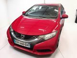 une Honda Civic rouge garée dans un garage