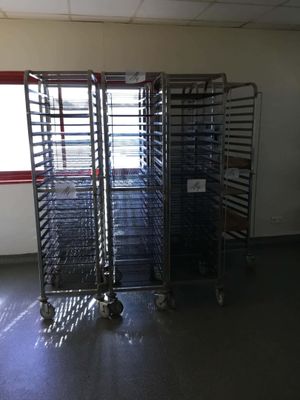 many trays of food on the cart in the room