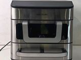 a silver and black oven sitting on a counter