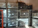 many cages and pallets in a warehouse with a fork lift