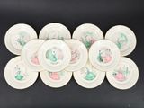 six white plates with green and pink designs are stacked on top of each other