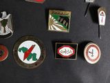 many different types of pins on a black surface
