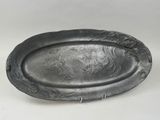 an old silver plate with a lion on it sitting on a white surface