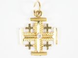 une image représentant une croix en or ornée d'un diamant au centre