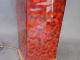 a red lamp that is on a table next to a lamp