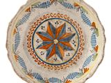 a small decorative plate with a flower design on it