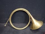 an old brass trumpet sitting on top of a black surface