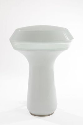 a white vase that is sitting on a white surface