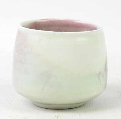 a close up of a cup on a white surface