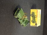 a green toy truck and a yellow box on a black surface