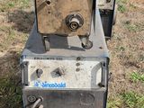 a machine that is sitting on the ground in the grass