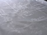 a bed with a white comforter and white sheets on it