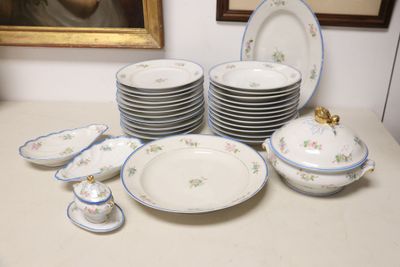 a lot of plates and bowls on the table