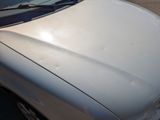 a white car that is parked in a parking lot