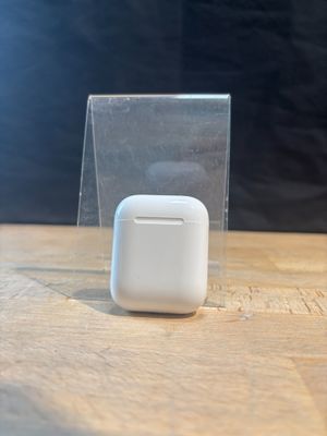an apple airpods sitting on a table next to a clear box