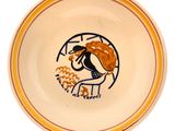 yellow and white plate with a drawing of a dog eating food