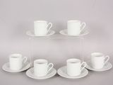 six white cups and saucers are arranged on a clear shelf