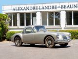 a silver car parked in front of a building