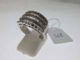 a close up of a ring on a white surface with a price tag
